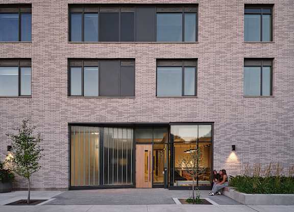 people sitting in front of a brick building