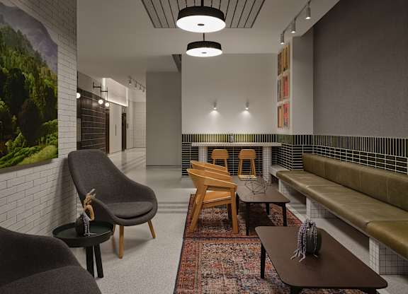 a living room with a couch and chairs and a table