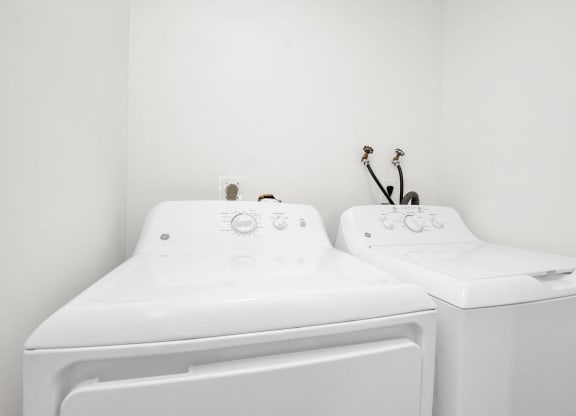 the laundry room has two washes and a dryer