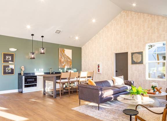 A living room with a grey couch and a coffee table.