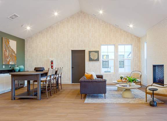 A living room with a brown couch and a wooden floor.