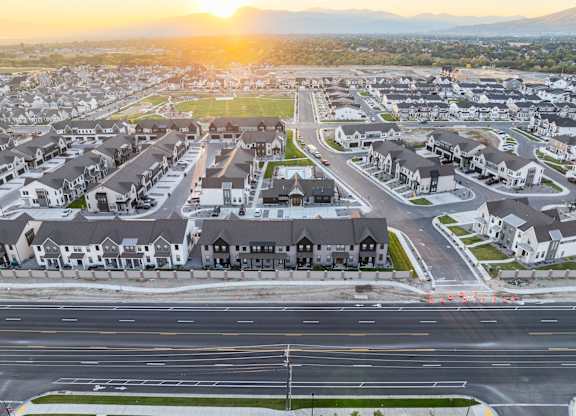 A sunset view of a residential neighborhood with houses and streets.