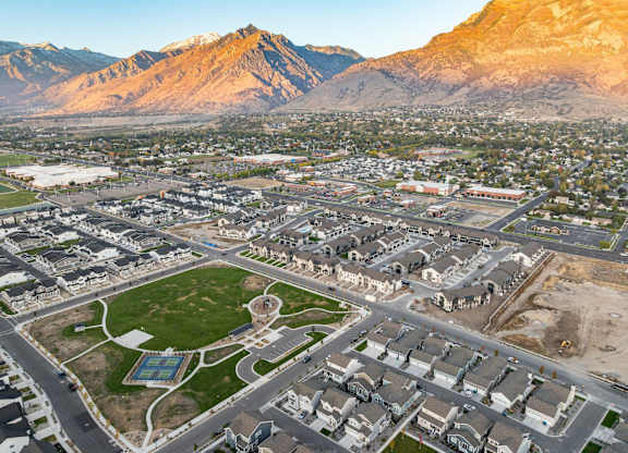 A view of a residential area with houses and a park.
