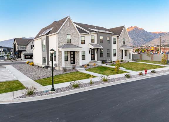 A large house with a mountain in the background.