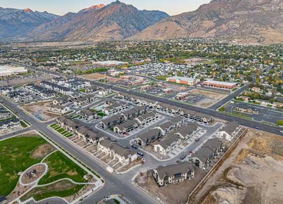 A large housing development with a mountain range in the background.