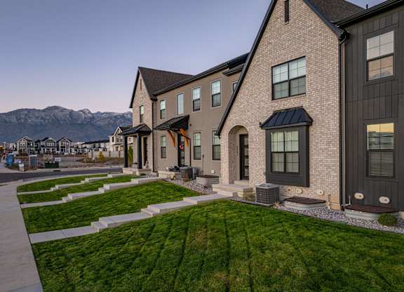 A row of houses with a mountain in the background.
