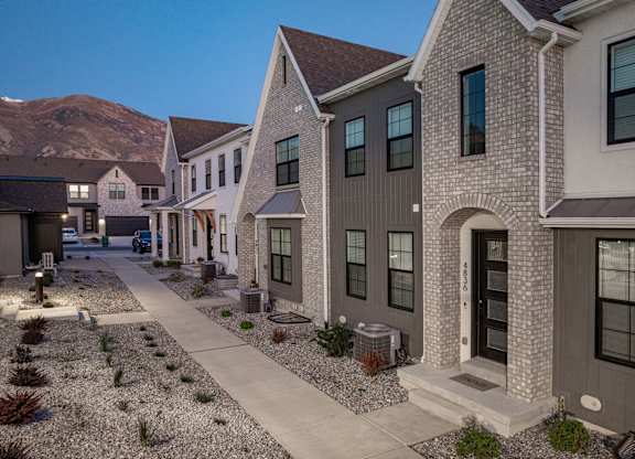 A row of houses with a mountain in the background.