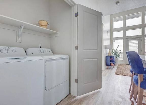 A white washing machine and dryer in a laundry room.