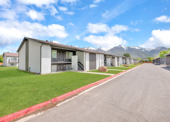a row of rental houses with mountains in the background