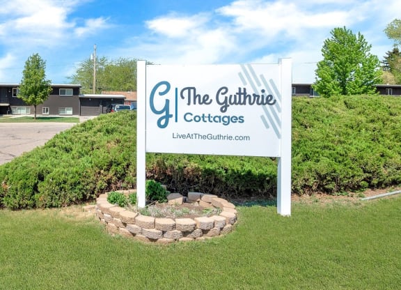 a sign for the gourmet coffees company in front of a grassy field
