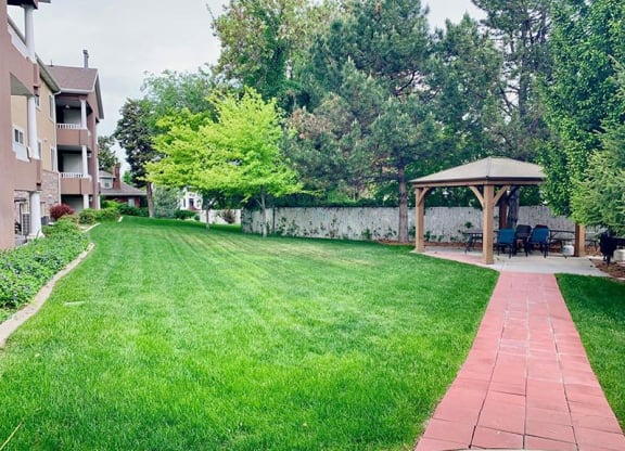 a backyard with a lawn and a gazebo