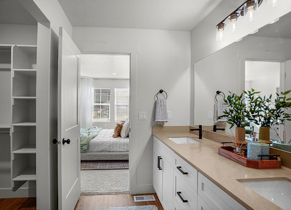 A bathroom with a white door and a white sink.