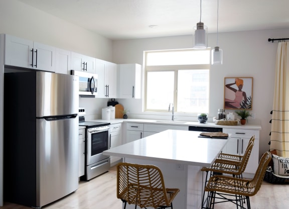 a kitchen with white cabinets and a white counter top