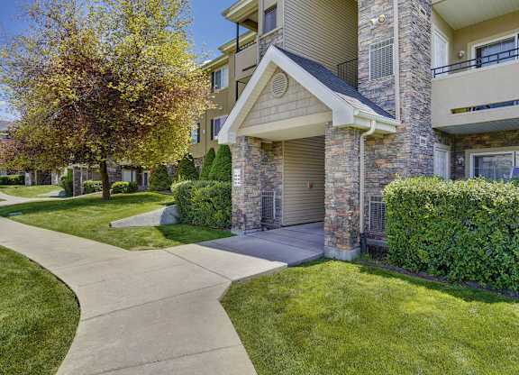 A residential building with a stone facade and a garage door.