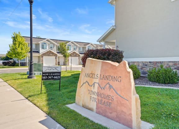 the building where the apartments are located has a sign for the leasing office