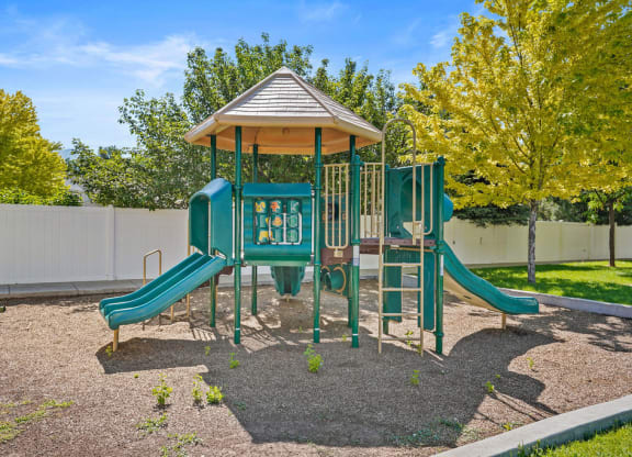 a playground with a pavilion and a swing set