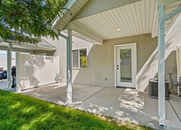 the front entrance of a house with a white door and a porch