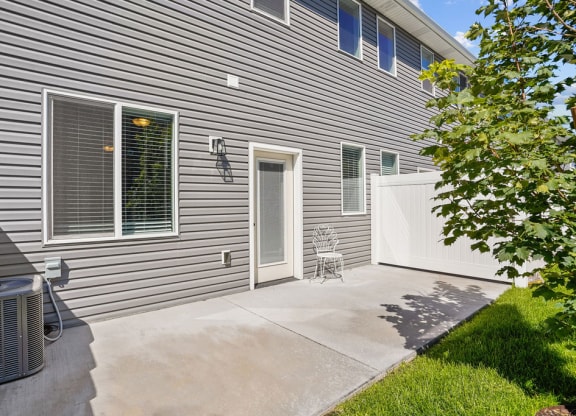 a side view of a house with a patio and a door