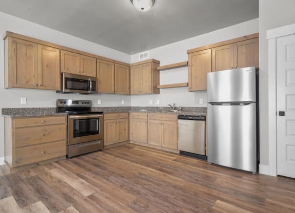 a kitchen with wooden cabinets and stainless steel appliances