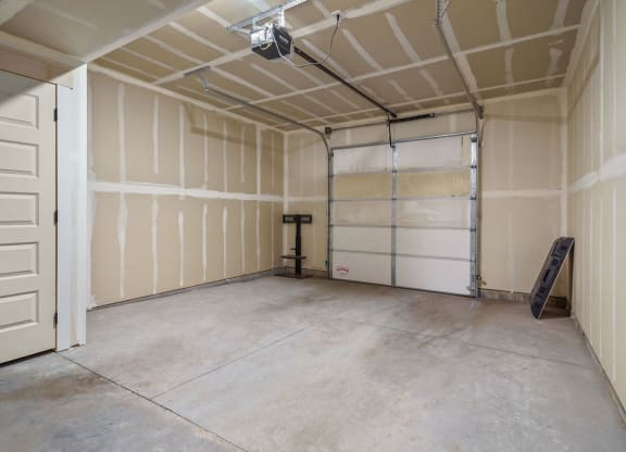 the inside of a garage with white walls and a door