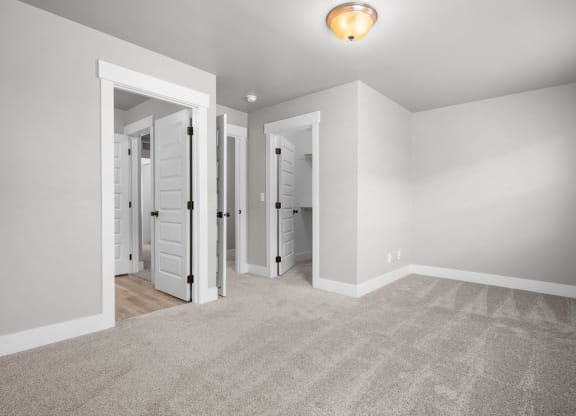a bedroom with a closet and a door to a mirrored closet