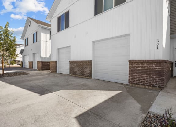 a white garage door on the side of a building