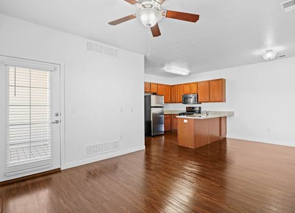 A kitchen with wooden floors and white walls.