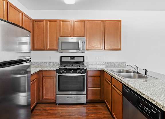 A kitchen with wooden cabinets and stainless steel appliances.