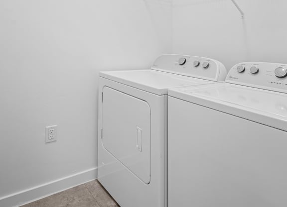 A white washer and dryer in a laundry room.