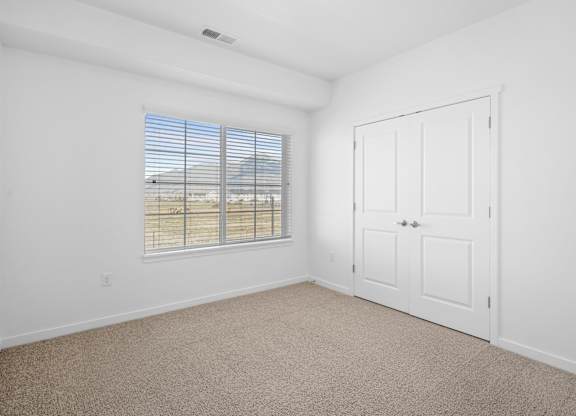 A room with a window and a door.