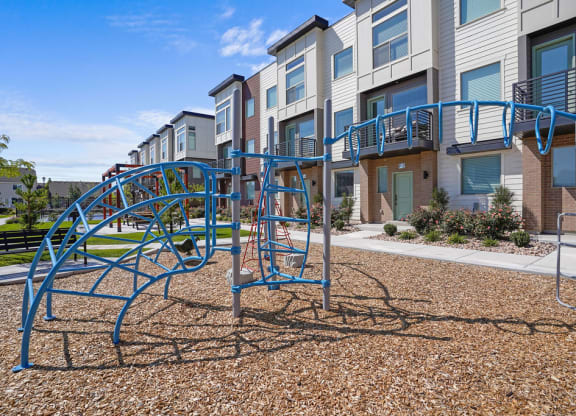 an empty playground in front of an apartment building