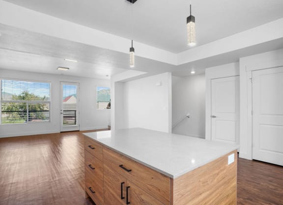 an empty kitchen with white walls and wood floors