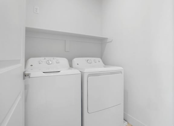 a washer and dryer in a room with white walls