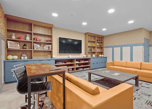 A living room with a brown table and orange couch.
