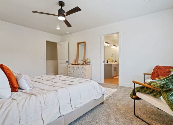 a bedroom with a bed and a ceiling fan