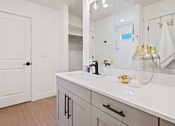 a white bathroom with a sink and a mirror