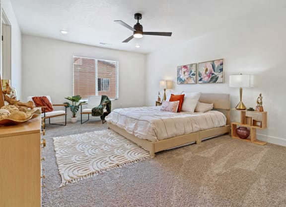 a bedroom with a bed and a ceiling fan