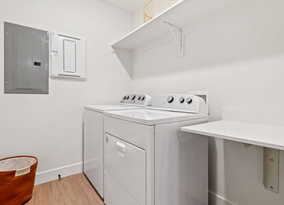 a white laundry room with a washer and dryer in it