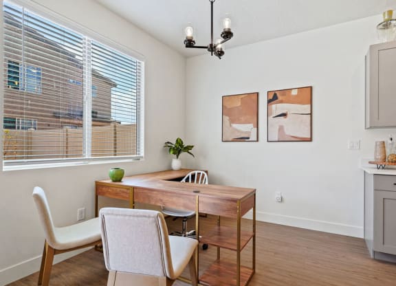 a dining room with a table and chairs and a window