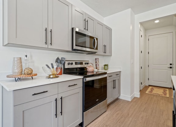 a kitchen with white cabinets and a microwave