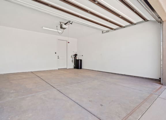 an empty room with a door and a ceiling fan