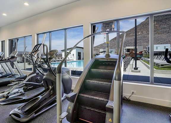 A gym with treadmills and a stair climber.