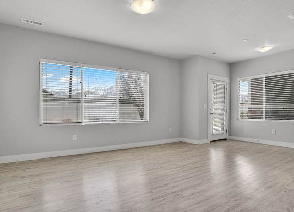 A room with a large window and a door.