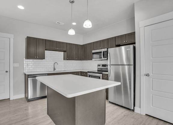 A modern kitchen with a large island in the center.