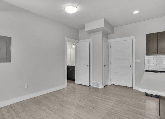 A white room with a door and a window.
