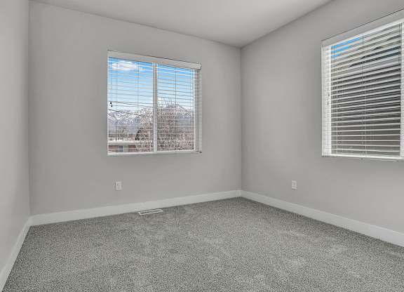 A room with a window showing a snowy landscape outside.