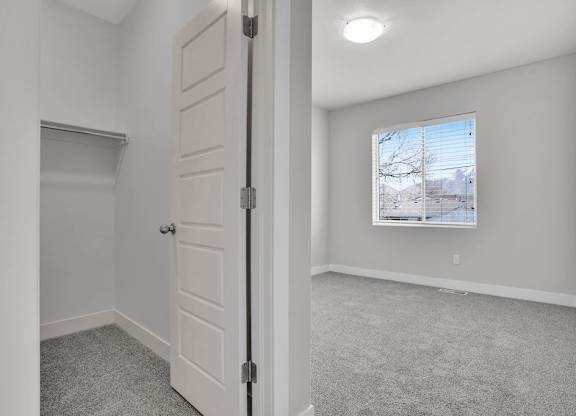 A room with a white door and a window showing a snowy landscape outside.