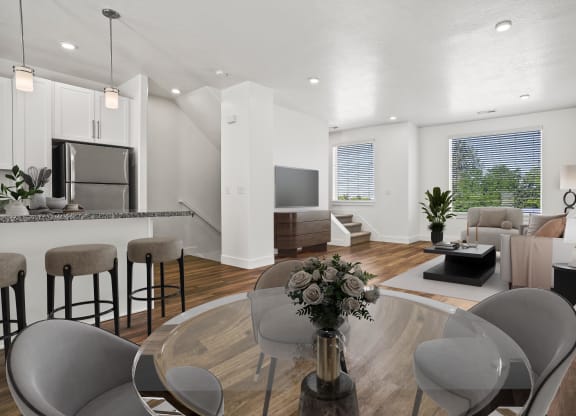 a living room and dining room with a table and chairs at Aero Luxury Townhomes in Layton, Utah.