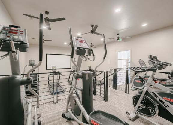a gym with exercise bikes and a chalkboard on the wall at Aldara Apartments in Saratoga Springs, Utah