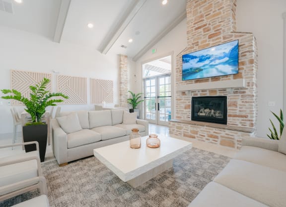 a living room with couches and a coffee table and a fireplace at Aldara Apartments in Saratoga Springs, Utah